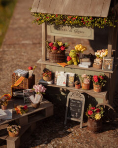 Miniatura de parada de libros y rosas de Sant Jordi hecha de madera.